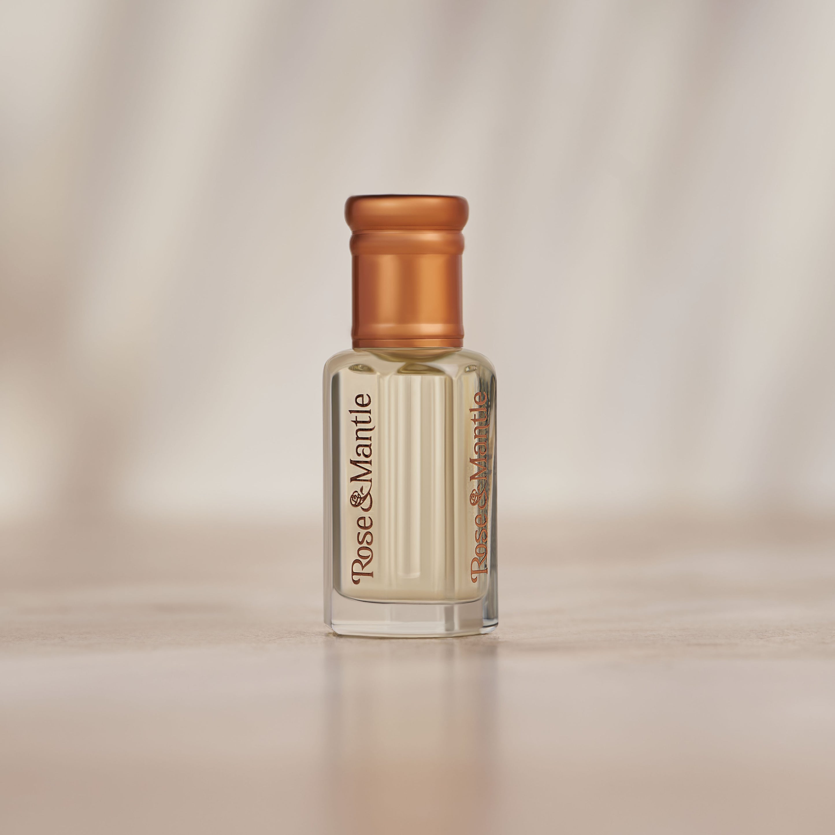Rose & Mantle logo printed vertically on a fragrance bottle